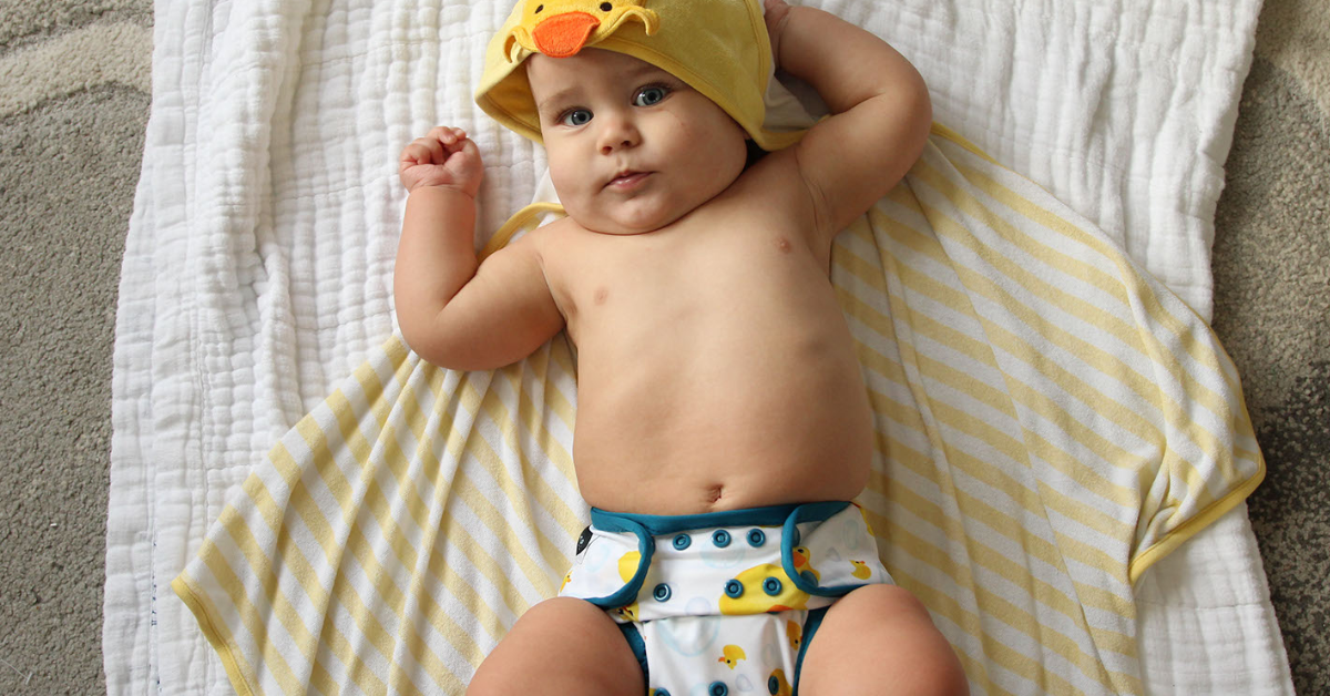 Baby with duck cloth diaper and towel